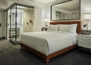 
a hotel room with a bed and a dresser at Pendry San Diego in San Diego
