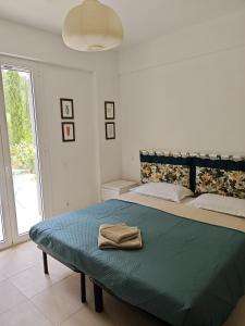 a bedroom with a bed with a towel on it at Villa Buras in Skinária