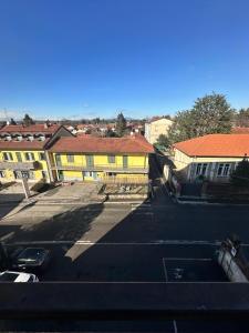 a view of a parking lot with yellow buildings at Dante appartamento in Fagnano Olona +24 photos