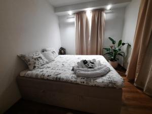 a bedroom with a bed with towels on it at Cozy Zdrój in Lądek-Zdrój