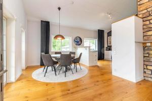 a kitchen and dining room with a table and chairs at VGO824-Boras-Nabbagatan-38 in Borås