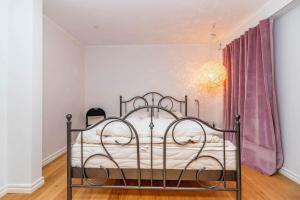 a bedroom with a metal bed in a room at VGO824-Boras-Nabbagatan-38 in Borås