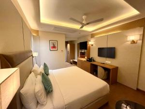 a hotel room with a bed and a television at Lalit hotel in Udaipur