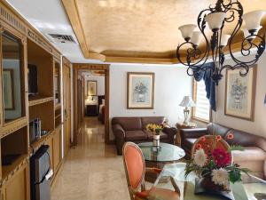 a living room with a couch and a table at Hotel Hacienda Real in Ciudad del Carmen