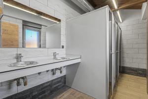 a bathroom with two sinks and a mirror at Albergue La Santa Siesta in Villadangos del Páramo +77 photos