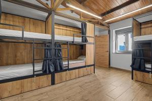 a room with three bunk beds in it at Albergue La Santa Siesta in Villadangos del Páramo