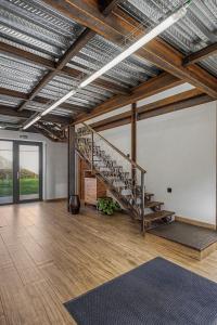 a large room with a staircase in the middle of it at Albergue La Santa Siesta in Villadangos del Páramo