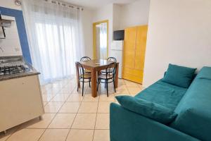 a living room with a couch and a table at Appartamenti La Mer in San Benedetto del Tronto