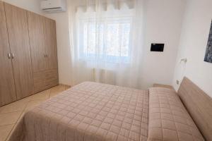 a bedroom with a bed and a window at Appartamenti La Mer in San Benedetto del Tronto