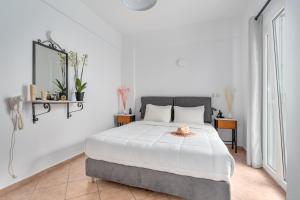 a bedroom with a bed with a hat on it at Ornos Apartments in Ornos