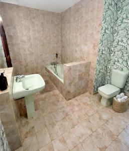a bathroom with a sink and a tub and a toilet at Chambres de charme - 2 chambres indépendantes avec salles de bains privatives in Corte