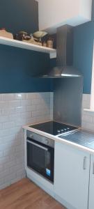 a kitchen with a stove and a counter top at spacious self-contained accommodation 135 cantebury road Herne bay CT6 5RZ in Kent