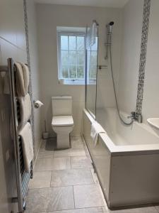 a bathroom with a tub and a toilet and a sink at Charnock Farm in Leyland +73 photos