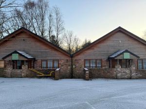 a large brick building with snow on the roof at Charnock Farm in Leyland