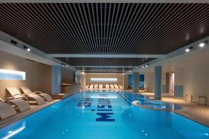 a large swimming pool in a hotel lobby at Grand Hotel Misurina in Misurina