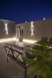 a patio with a chair and tables and lights at شاليه لانتانا in Taif