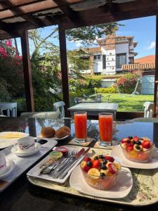 a table with plates of food and drinks on it at HOTEL BOUTIQUE Santa Helena in Villa de Leyva
