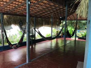 a room with hammocks in the middle of a room at REDÁRIO Botos de Alter in Alter do Chao