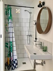 a bathroom with a sink and a shower curtain at Casa Taller en Penelles in Penellas