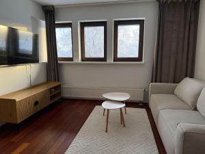 a living room with a couch and a table at Cozy Urban Escape in Otepää