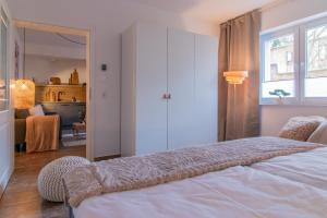 a bedroom with a bed and a living room at Innenhof-Quartier in Meerane +5 photos