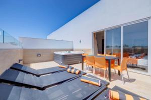 a living room with a table and chairs and a bedroom at Bayside A Apartments in St. Julianʼs