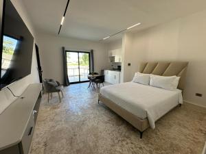a bedroom with a bed and a living room at Arena Aparta Hotel in Punta Cana