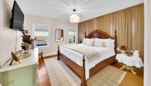 a bedroom with a large bed and a television at In-ground pool, hot tub, fire pit, massage room! in Tulsa