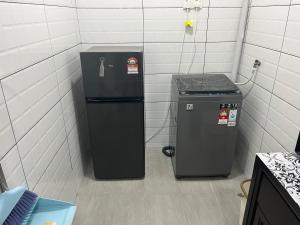 two trash cans sitting next to each other in a room at SaiMurni Homestay in Jerantut