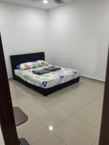 a bed in a room with a white floor at SaiMurni Homestay in Jerantut +3 photos