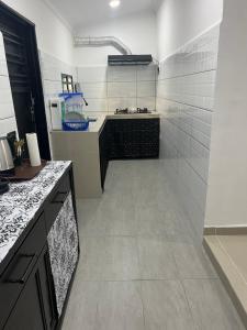 a kitchen with a sink and a counter top at SaiMurni Homestay in Jerantut