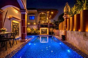 a swimming pool in a house at night at 855 Villa in Siem Reap