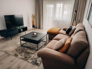 a living room with a couch and a coffee table at Apart 53 in Turda