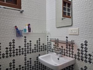 a bathroom with a sink and a mirror at Eleeza Homestay in Cochin +44 photos