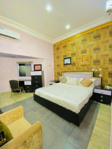 a bedroom with a large bed and a television at Garden Atlantis Hotel in Enugu