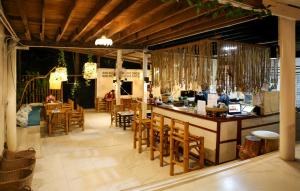 a restaurant with a bar and tables and chairs at Haad Chao Phao Resort in Haad Chao Phao