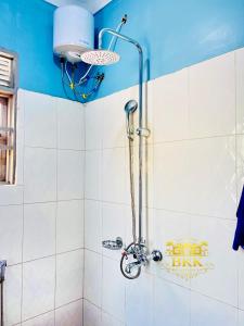 a shower in a bathroom with a blue ceiling at BKK Residences in Fort Portal +12 photos
