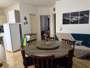 a kitchen and dining room with a table and chairs at Apartamento Sunset 101 in Palhoça +7 photos