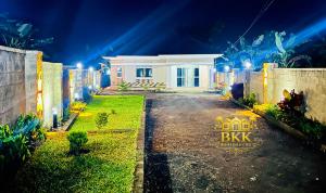a white house with lights in front of it at BKK Residences in Fort Portal