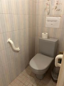 a bathroom with a toilet and a sign on the wall at Le gîte a momo in Annoire +18 photos