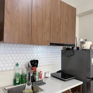 a kitchen with a sink and a refrigerator at Skyline Studio Marigondon in Marigondon