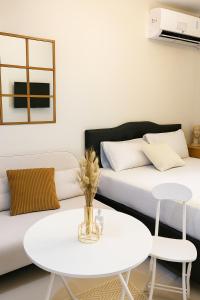 a living room with a white table and a couch at Skyline Studio Marigondon in Marigondon +3 photos