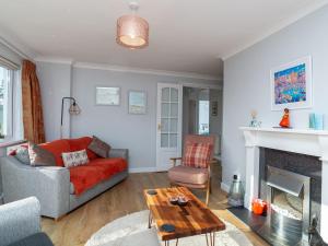 a living room with a couch and a fireplace at Bosula in Fowey