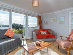 a living room with a couch and a table at Bosula in Fowey