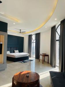 a bedroom with a bed and a coffee table at Vantage View - Penthouse Apartment in Lucknow