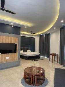 a living room with a bed and a coffee table at Vantage View - Penthouse Apartment in Lucknow
