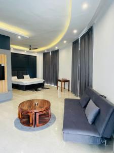 a living room with a couch and a coffee table at Vantage View - Penthouse Apartment in Lucknow