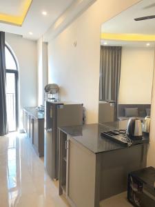 a kitchen with a counter top and a refrigerator at Vantage View - Penthouse Apartment in Lucknow