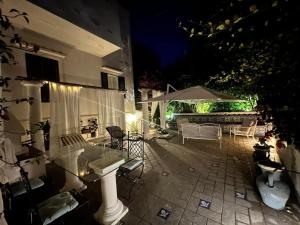 a patio with a table and an umbrella at night at CASA SOFIA in Anacapri