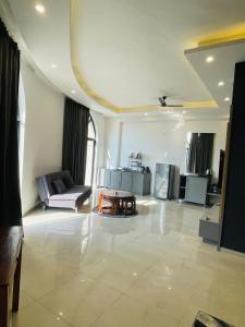 a living room with a couch and a table at Vantage View - Penthouse Apartment in Lucknow